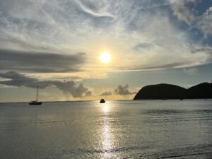 Boats on ocean with partly cloudy sunny skies